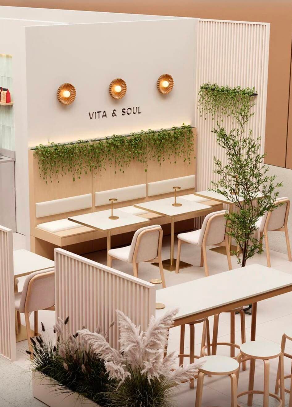 Innenraum des Vita & Soul Cafés mit Sitzbereich, Salbei-Grün und warmem Licht